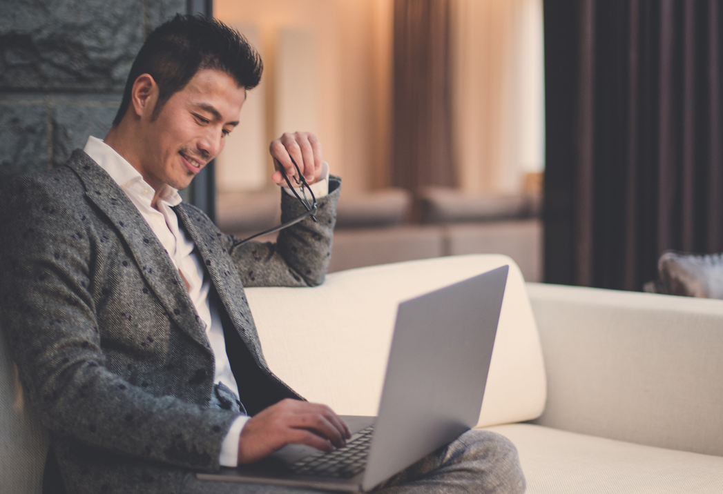 Smart Asian businessman working on his laptop